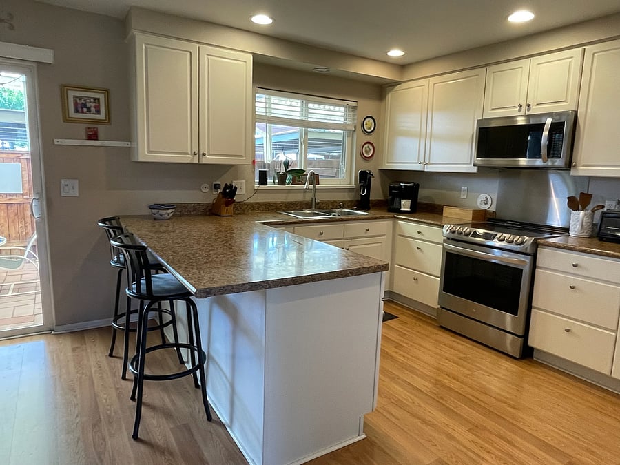 Kitchen with upgraded stove and microwave. Eat in kitchen/ dining area
