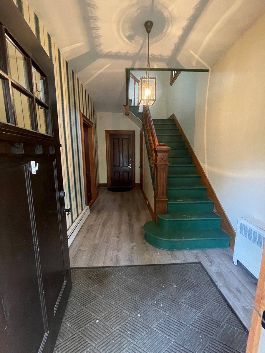 Foyer upon entering the building. Apartment door is straight ahead. It now has a "Apt 1" sign on the door.