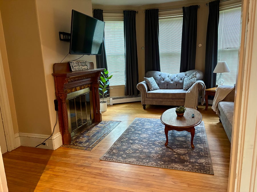 Living room with TV that has a FireStick already hooked up for you to log into!