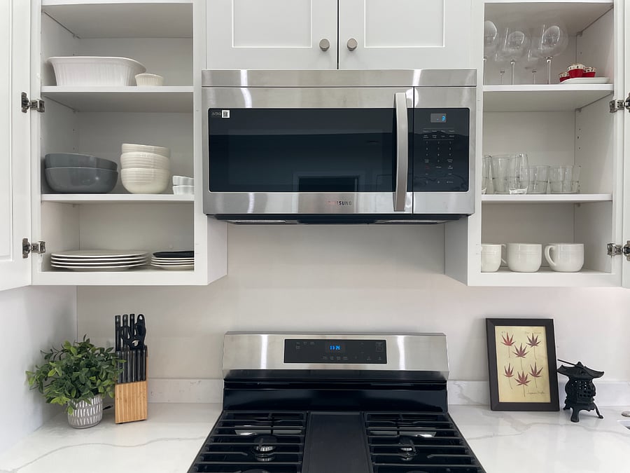 Kitchen with Brand New Appliance and stocked plate ware