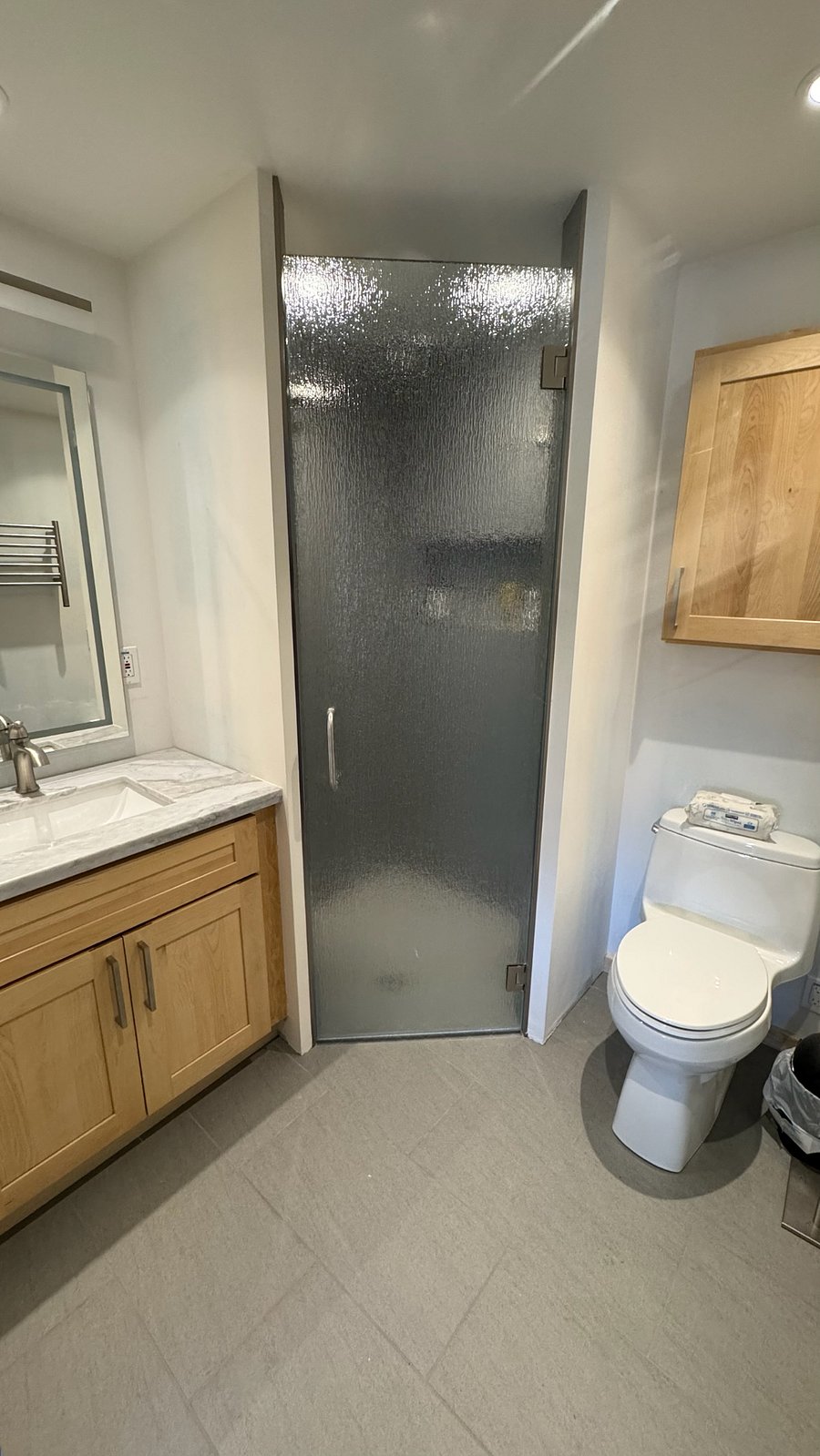 Bathroom with anit-fog lighted mirror, heated floors, heated towel rack and three-headed shower.