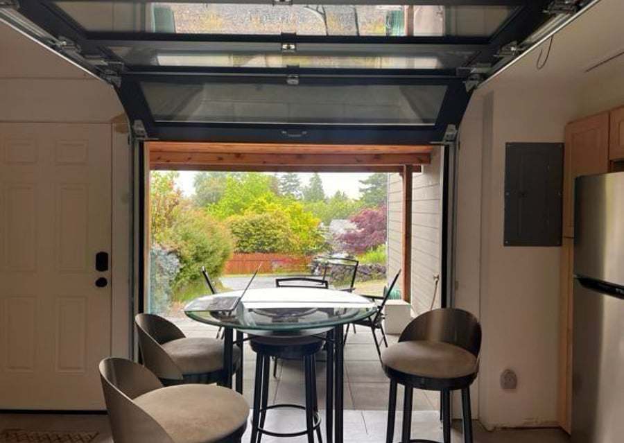 View looking out of the apartment, with the privacy screen and garage door open.