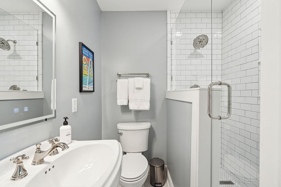 Bathroom #1 is located between the dining area and kitchen. Its newly renovated with a custom built tile standing shower and tile floors.
