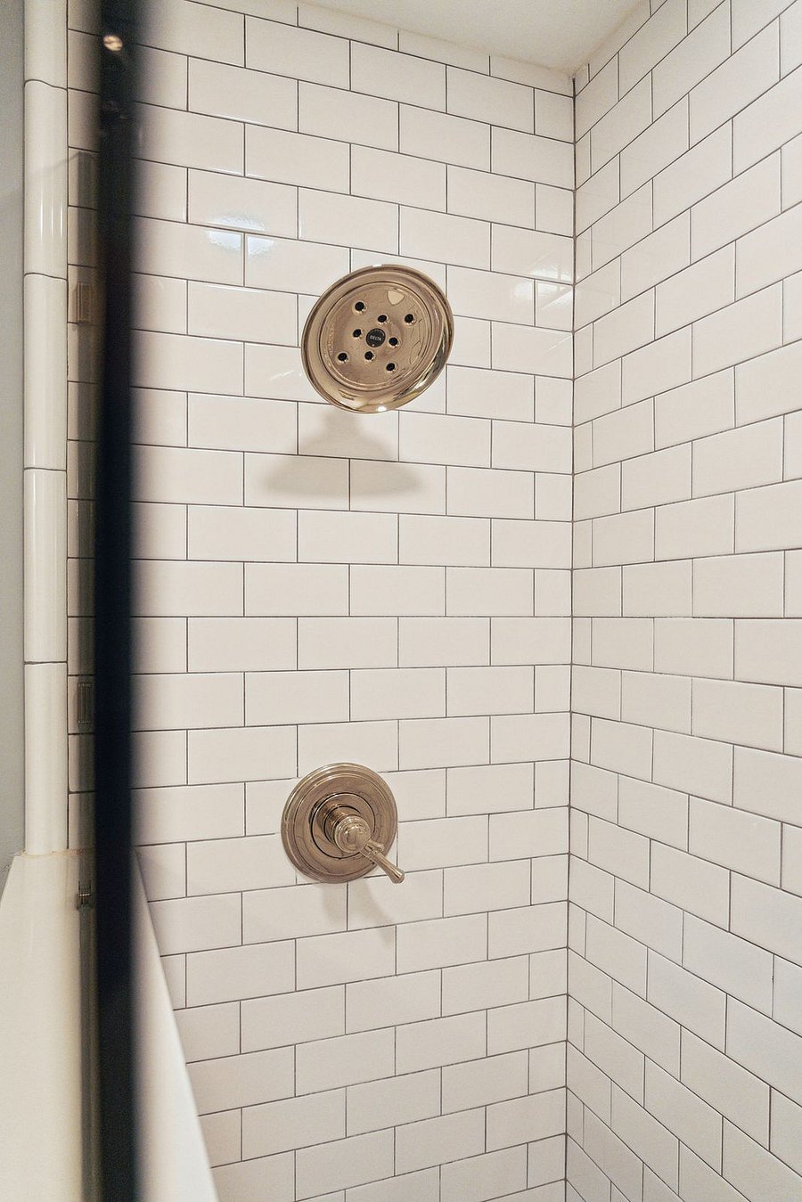 Bathroom #1 is located between the dining area and kitchen. Its newly renovated with a custom built tile standing shower and tile floors.