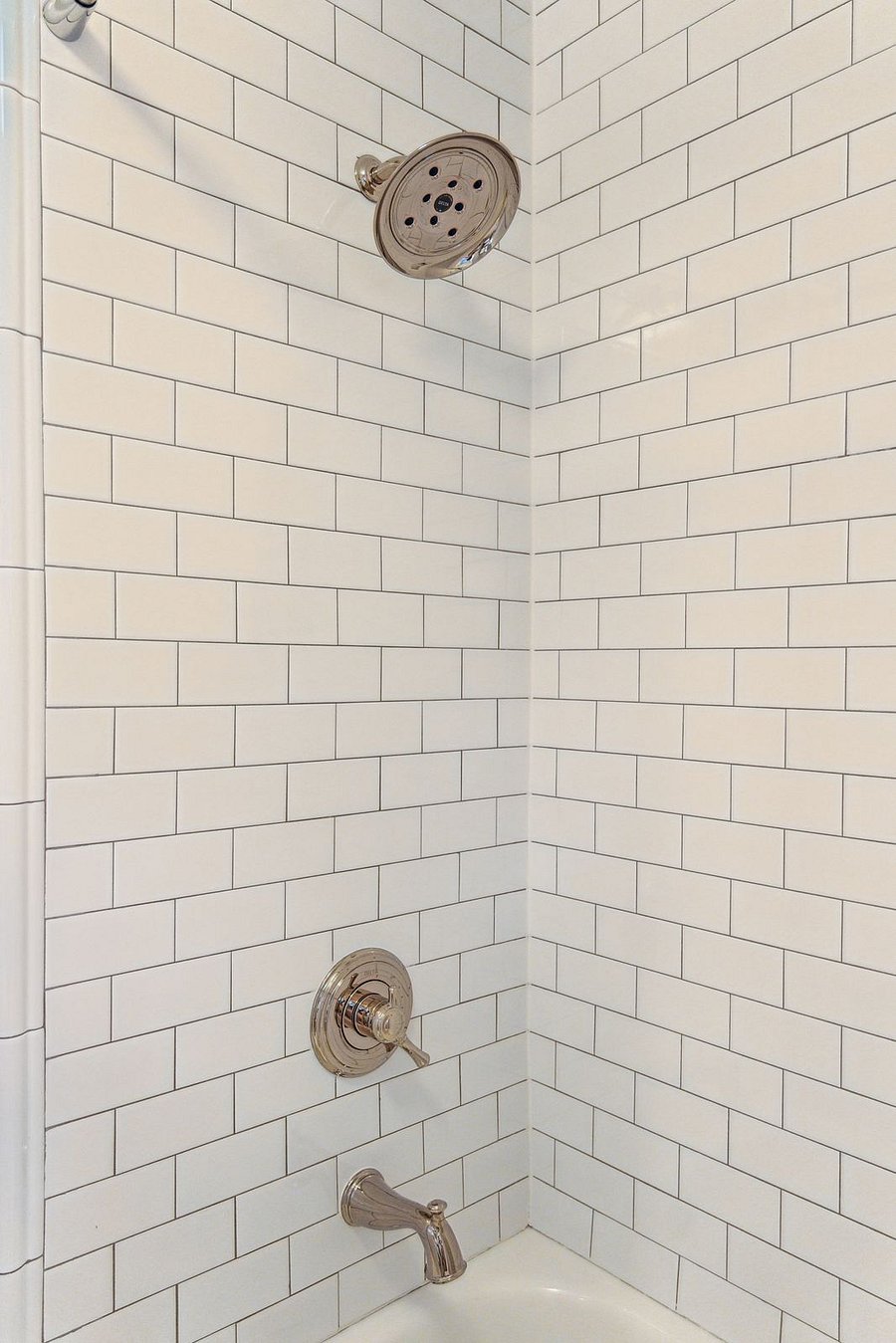 Bathroom #2 is located on the second floor and is also newly renovated. It includes a shower/tub combo with tiled walls and floors.