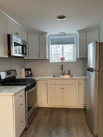 Cozy Kitchen with full size refrigerator, full size range and microwave.
