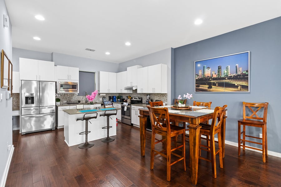A beautiful 6-person wooden dining set perfectly situated between the kitchen and the living room, making it easy to transition from a delicious dinner to relaxing on the couch.
