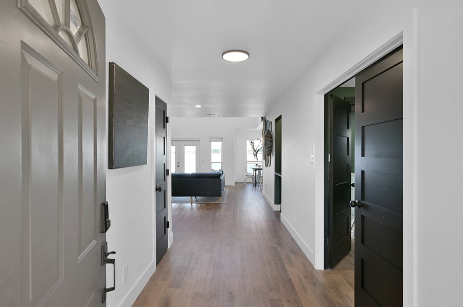 Here is the first view into our home. The entry hallway is wide open. The double doors to the right are the queen bedroom private suite.