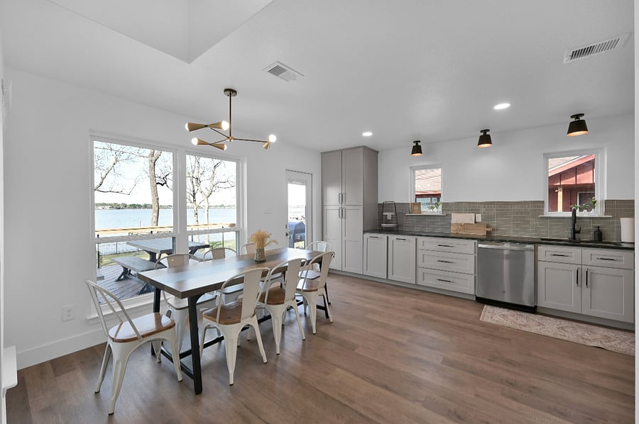 The kitchen and dining space are open concept with beautiful views of the lake.