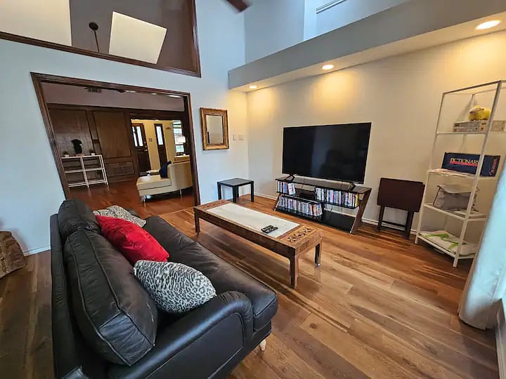Game Room - New 60-inch smart TV with overstuffed sofa, pillows, and throws. You can stream fav shows or watch our collection of DVDs, play board games, a Wii or do puzzles. To the right is door to the patio & pool.