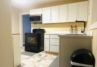 Stove and microwave with ample cabinet and counter space.