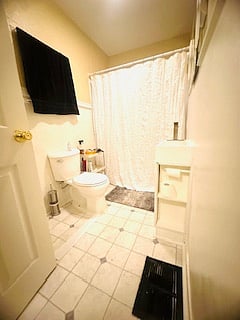Bathroom has a towel closet behind the door.