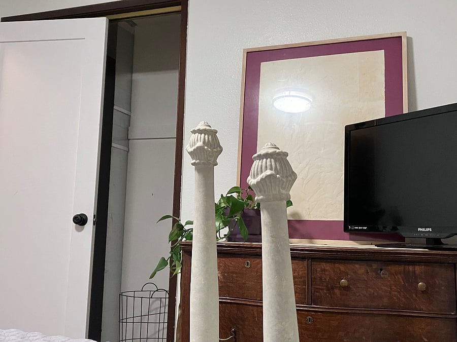 Old fashioned room, dresser, tv, closet, laundry basket.