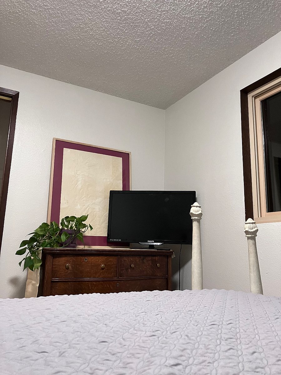Old fashioned bedroom, dresser, tv.