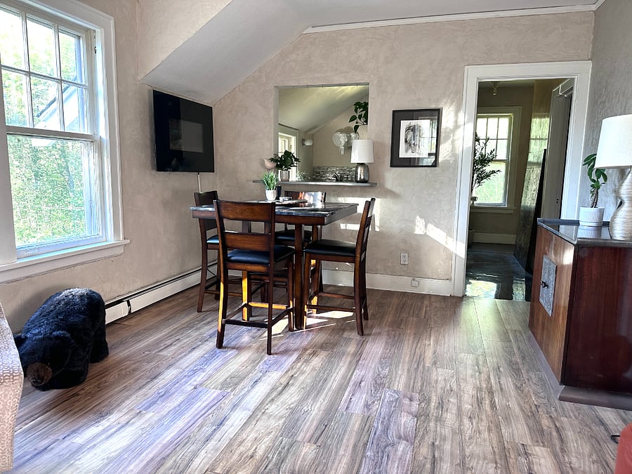 Eating area with electric wall fireplace.