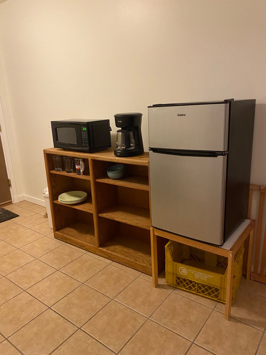 Mini fridge, coffee maker, microwave, toaster, crockpot in common hallway. 