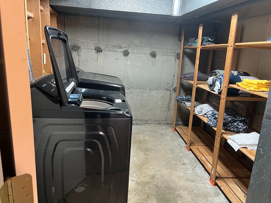 Laundry room with storage shelves