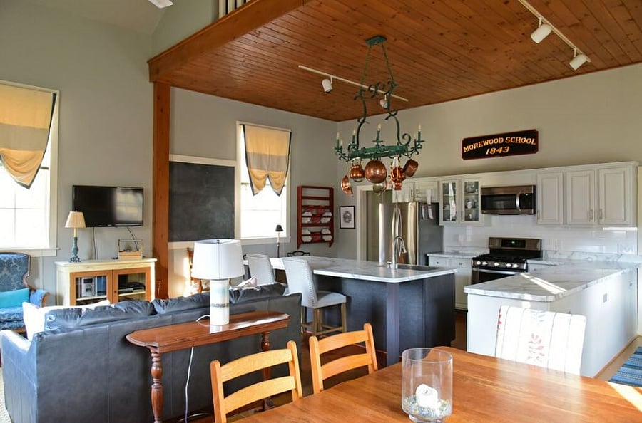 View from dining area to islands and modern kitchen.