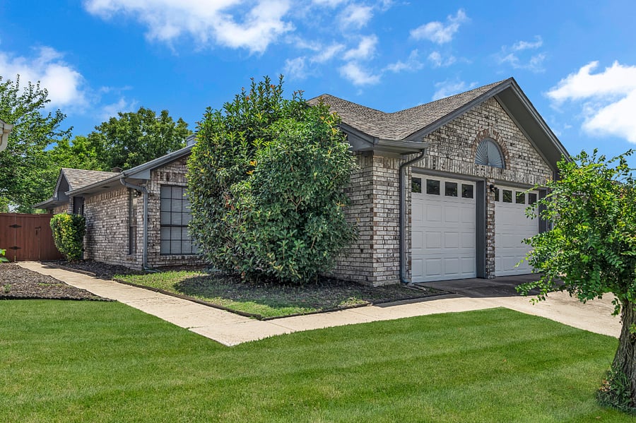 This home features a 2-car garage and a front-entry driveway, with a private entry on the left side and a covered front door.