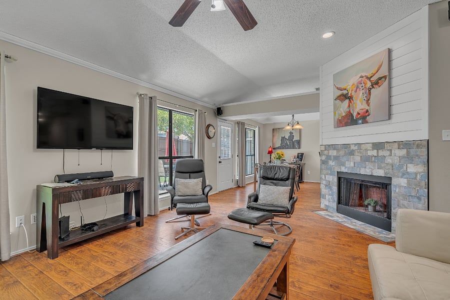 The living room provides two leather sofas and 2 recliner chairs.