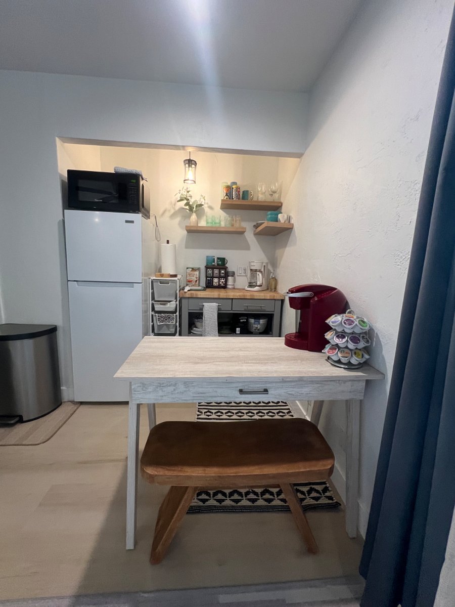 kitchenette has a small table with bench for sitting or dining at