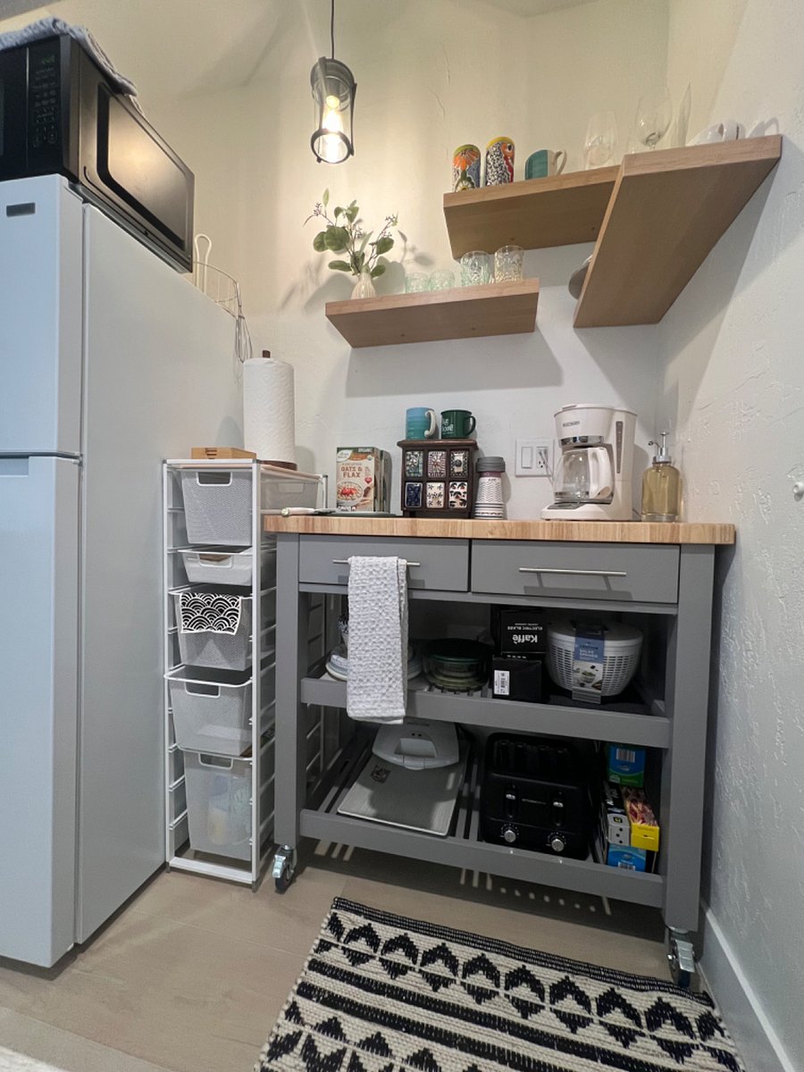 kitchenette with multiple coffee and tea hot water kettle, hot plate, dishes, toaster, air fryer, griddle, salad spinner, popcorn maker, rice cooker, microwave, new frdige