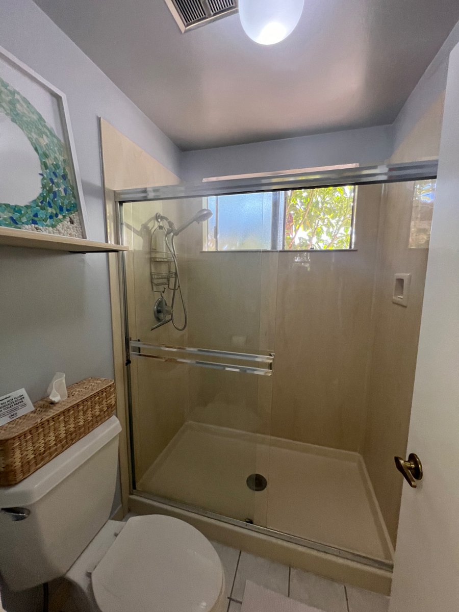 shower has nice foliage out the window for an enjoyable shower. The shower head various modes and is detachable