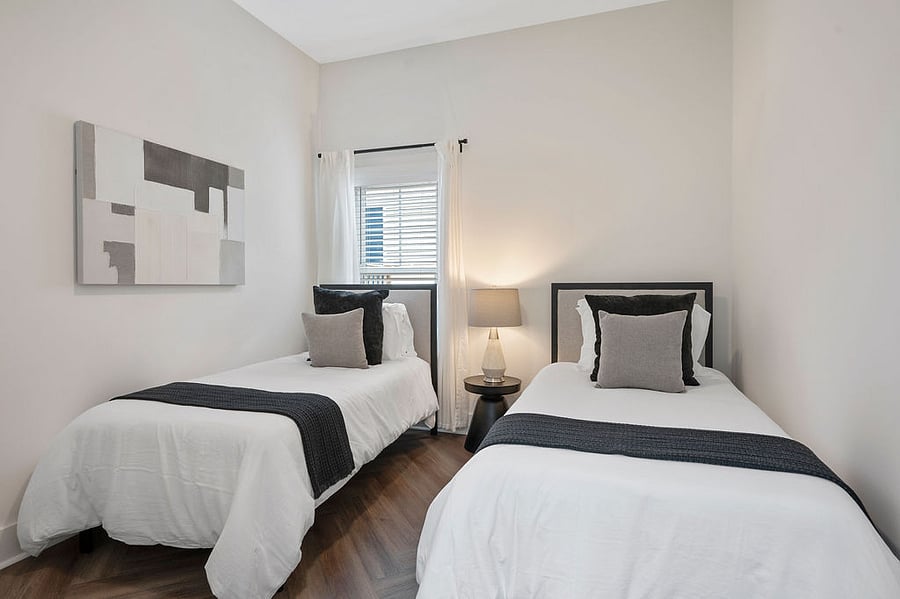 The cozy twin bed setup is perfect for friends or kids to rest and recharge.
