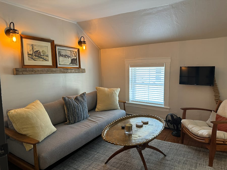 Living area with Queen sleeper, coffee table, smart TV, and 2 easy chairs...adjoins Kitchen