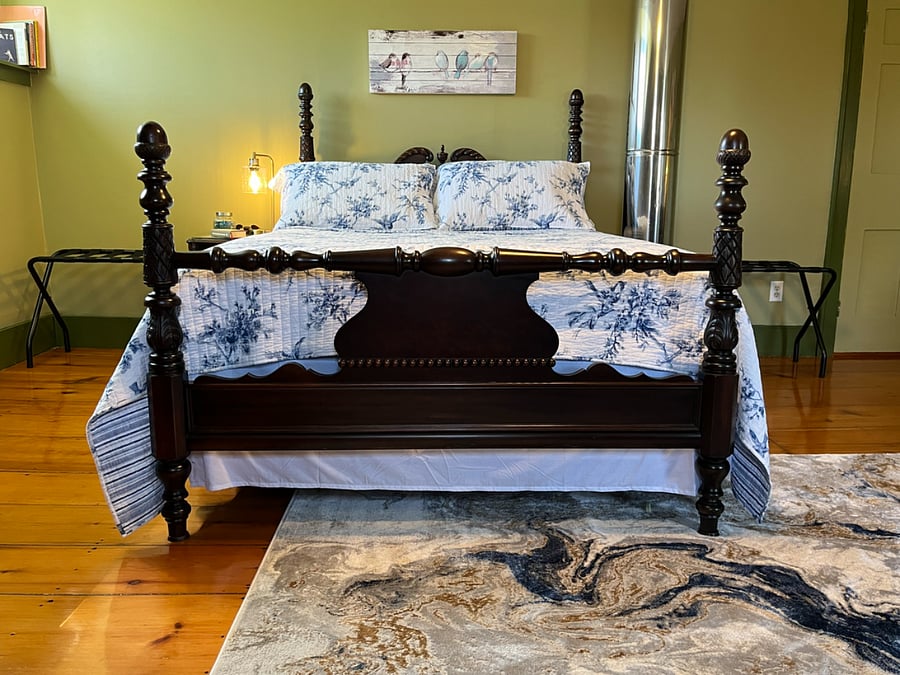Queen bed with medium firm mattress and quilted pad. Extra quilts ready for winter.