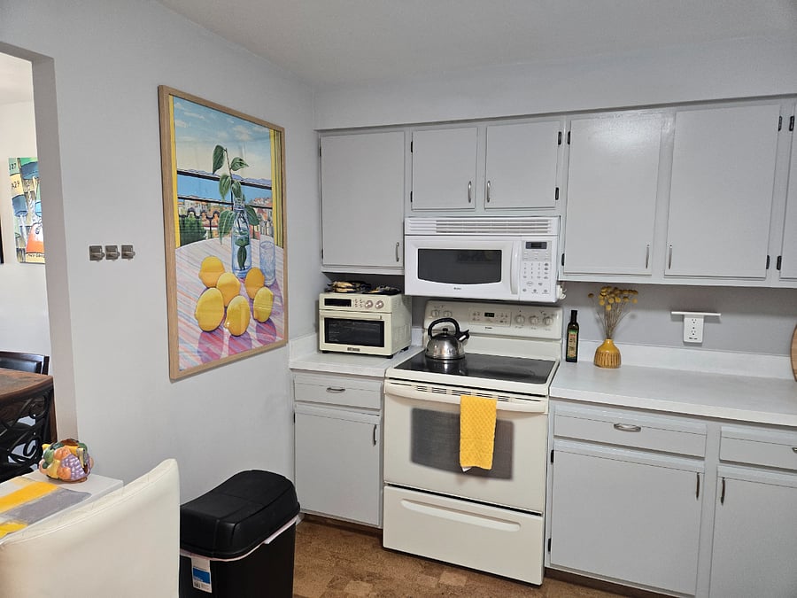 full kitchen with small island overlooking ocean
