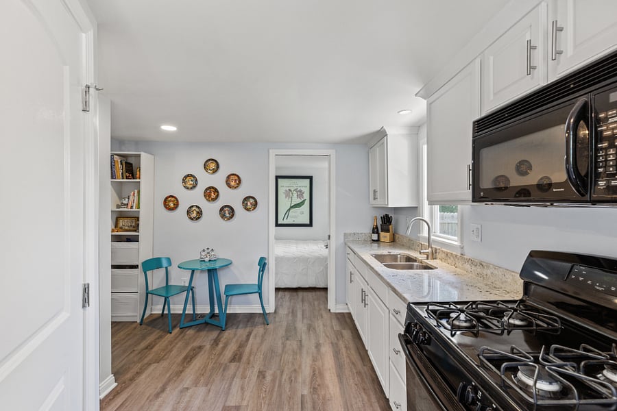 Kitchen/dining area with granite countertops & gas stove