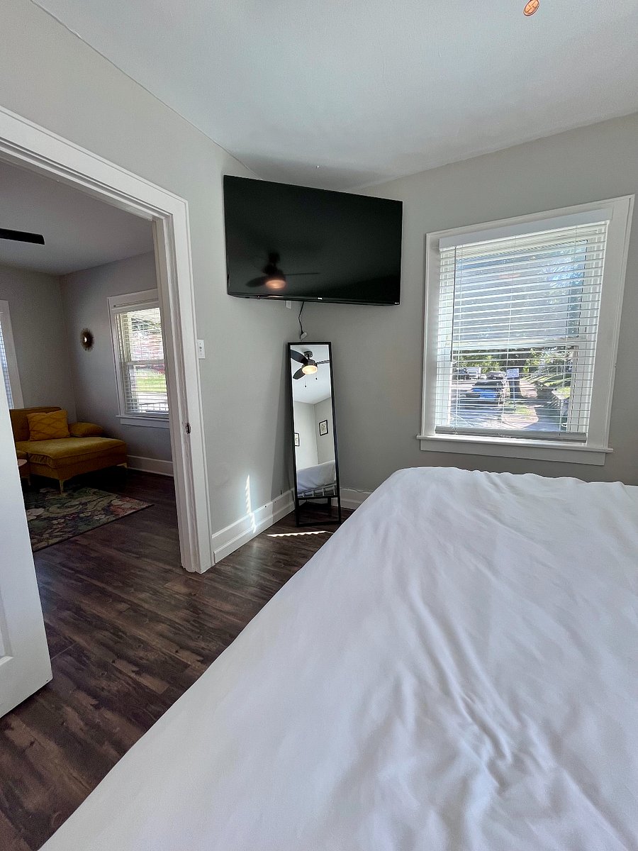 Main bedroom with large TV and night stands with charging stations