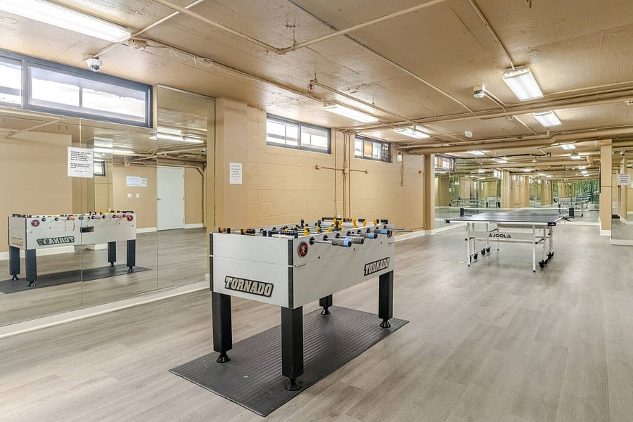 Spacious rec room with a Foosball table & Ping Pong table, and a guest restroom.