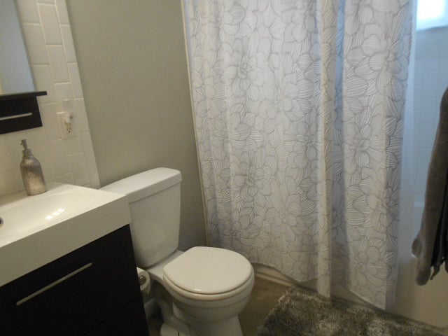 Bathroom features newer vanity and fixtures and also has subway tile shower surround as well as back splash for the sink.