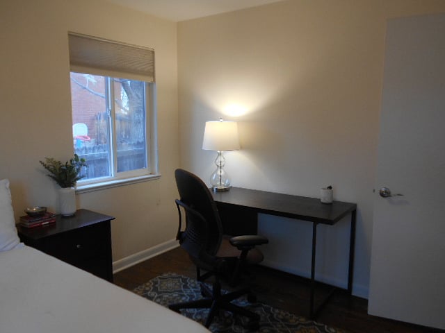 Secondary bedroom features a full bed with new mattress, disk, chair and lighting for working from home