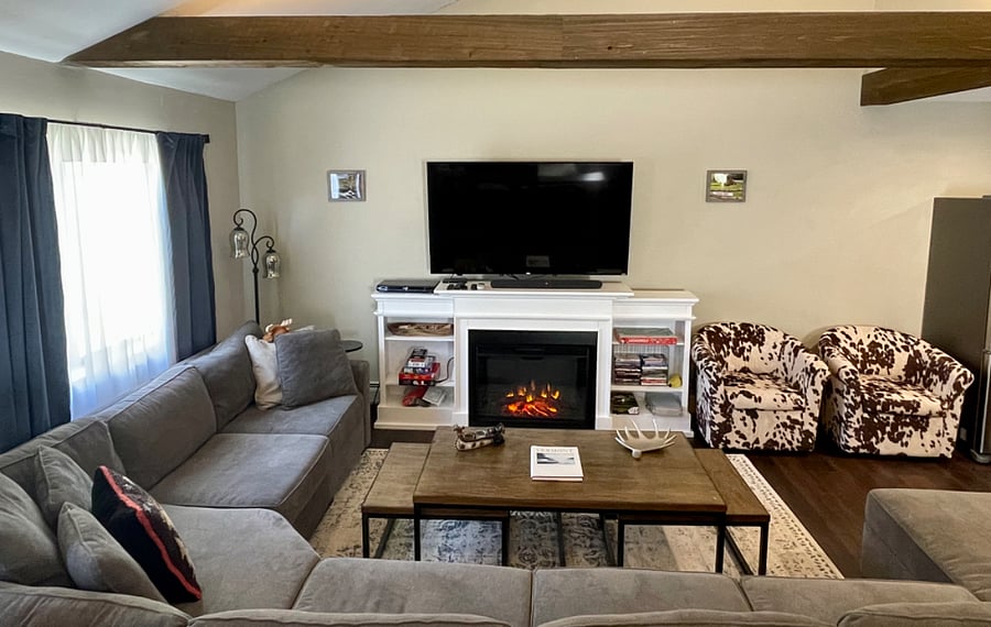 There is seating for everyone in this spacious living room with large Smart TV and Real Flame fireplace.