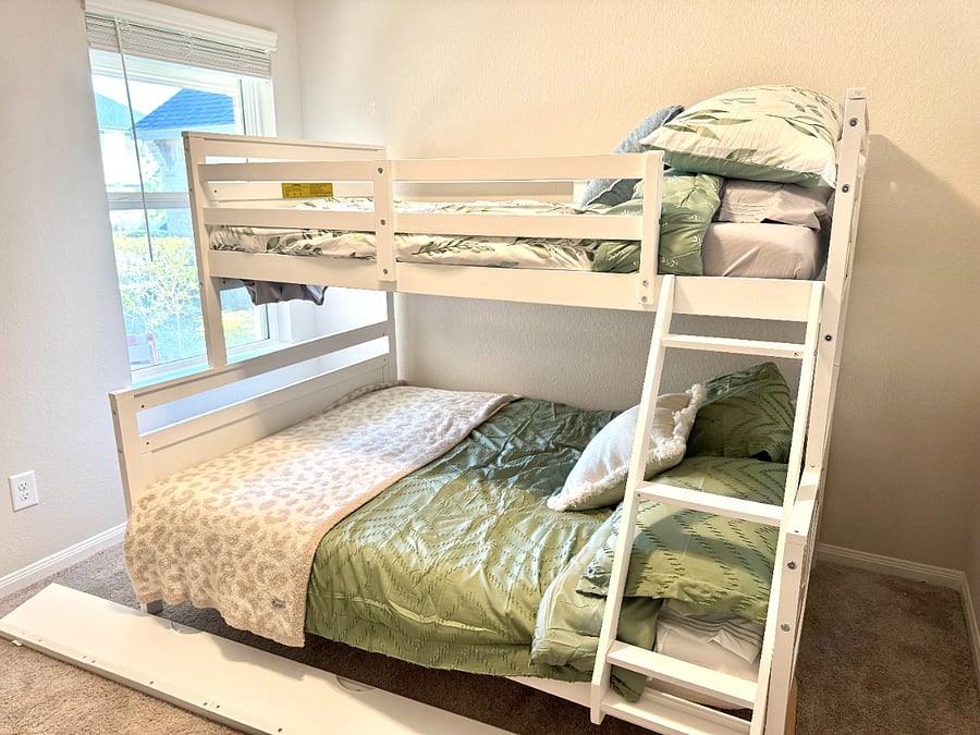 Bedroom 2 with full sized bed on bottom, twin sized bed on top, and pull out trundle bed (not yet fully furnished).