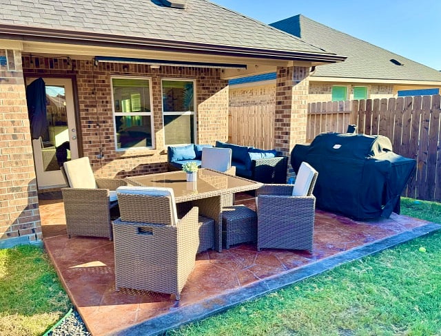 backyard patio with chairs pulled out of table