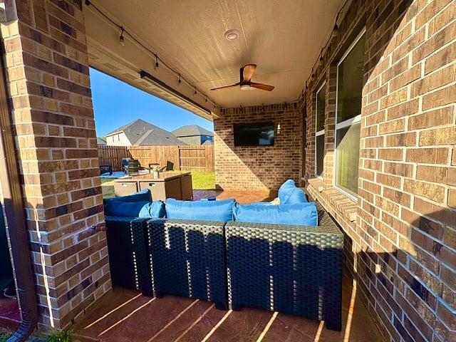 patio furniture with TV and fan view