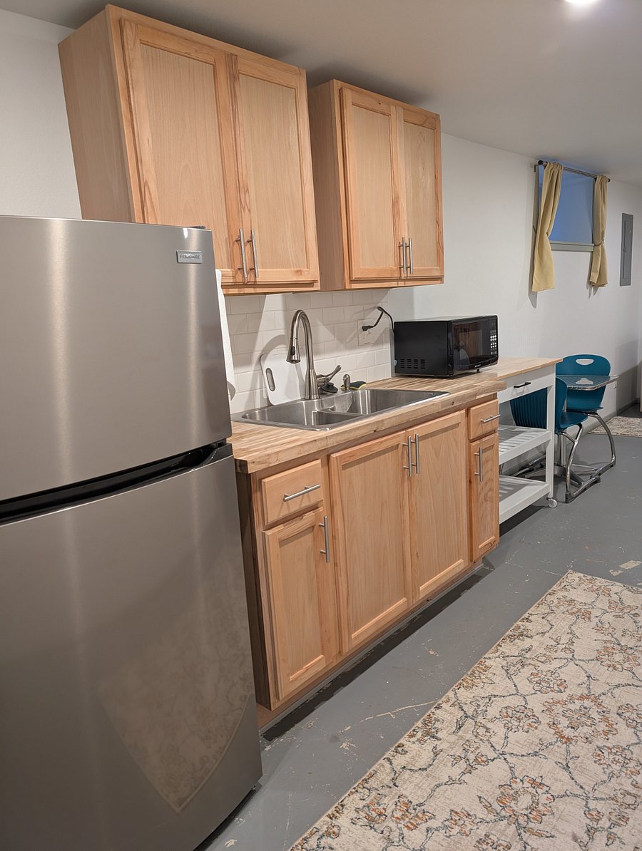 Efficiency kitchen with refrigerator, coffee maker, double sink, microwave, and all dishes included.