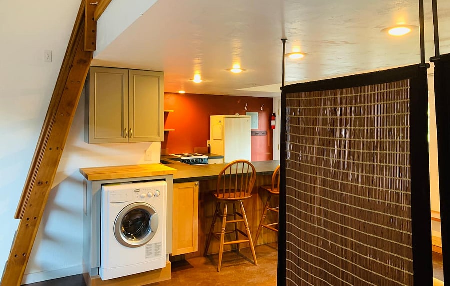 Washer/dryer and breakfast bar.