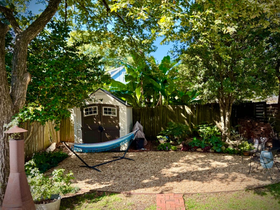 Backyard sanctuary with plenty of seating, fire pits, string lights and a grill.