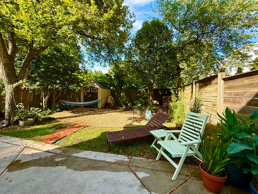 Backyard sanctuary with plenty of seating, fire pits, string lights and a grill.