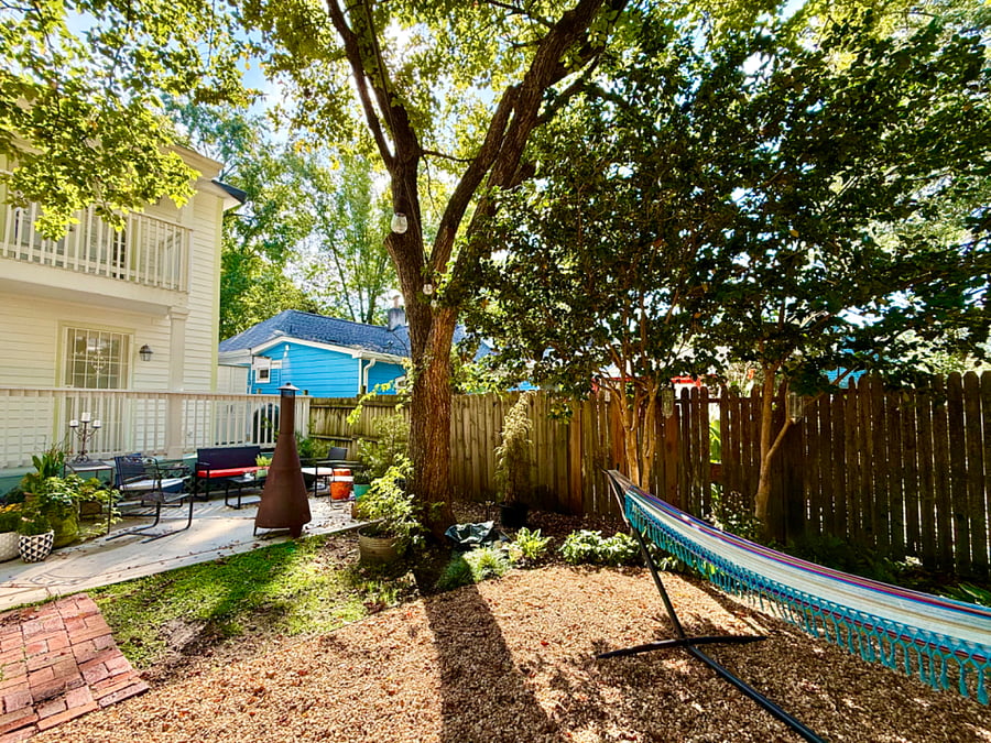 Backyard sanctuary with plenty of seating, fire pits, string lights and a grill.