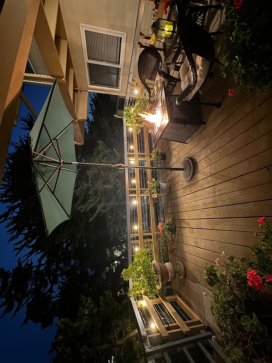Amazing deck! Fire pit table and lights around deck at night.