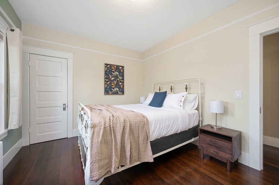 Another view of 1st bedroom. Door leads to spacious closet. Bedside lamps have USB charging ports.