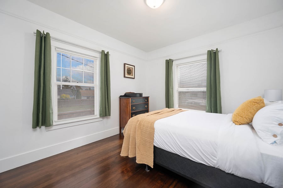 2nd bedroom on main floor. Queen sized bed. Black out curtains.