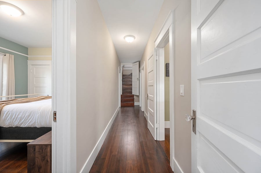 Hallway is wider than it looks. Stairs lead to upstairs living area and 4th bedroom.