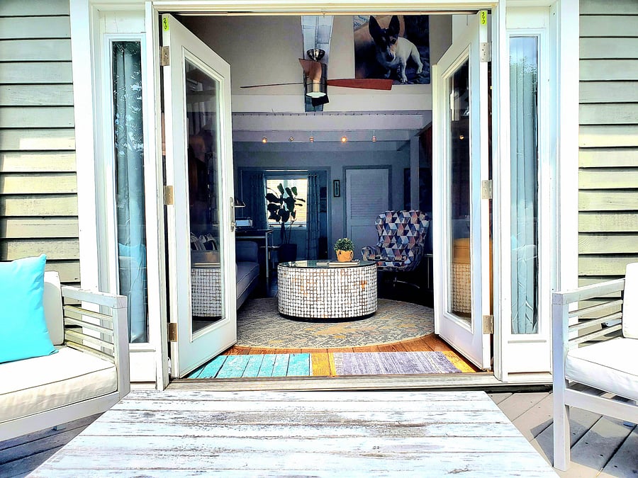 French doors open to back deck lounge